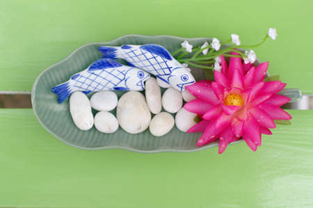 Lotus bloom in the plate on the tableの写真素材