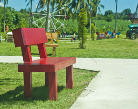 Red wooden park bench at a parkの写真素材
