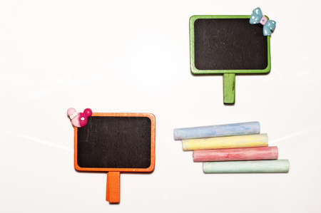 Blackboard and chalk for note on the white background の写真素材