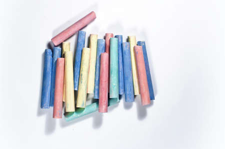 Multicolored chalk lined well and white backgroundの写真素材