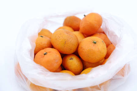 Oranges in bag on a white backgroundの写真素材