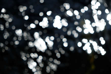 bokeh lights on black, shot of flying drops of water in the air