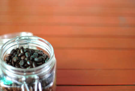 Detail of coffee beans in glass jar and textuerの写真素材