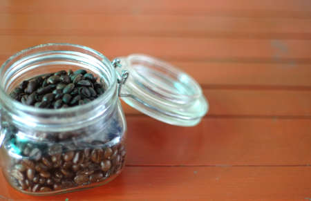 Detail of coffee beans in glass jar and textuer