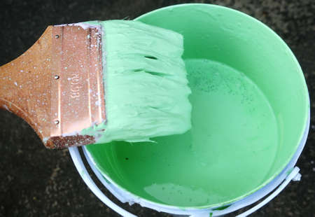 Painting of retro green radiator with brushの写真素材