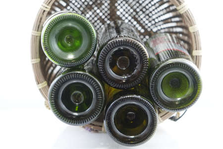 wine in wicker basket isolated on white backgroundの写真素材