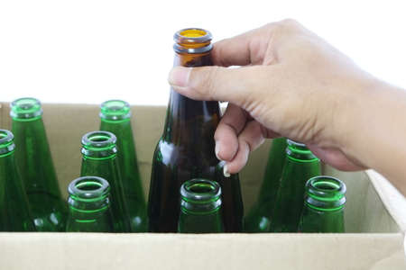 Many beer bottle in the hand on whiteの写真素材