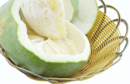 Green pomelo citrus fruit on wood Basket white backgroundの写真素材