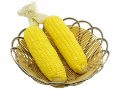 Corn cooked on wood basket white backgroundの写真素材