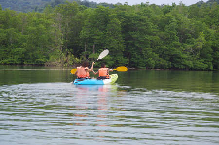 Family on kayaks and canoe tourの写真素材