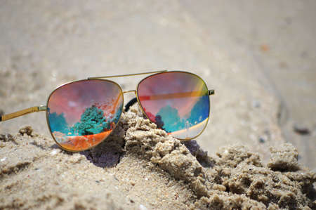 Sunglasses on the beach with beautiful of reflexの写真素材