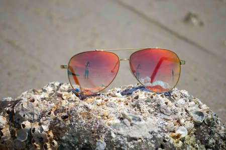 Sunglasses on the beach with beautiful of reflexの写真素材