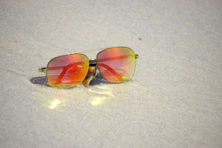 Sunglasses on the beach with beautiful of reflexの写真素材