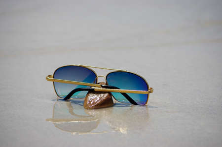 Sunglasses on the beach with beautiful of reflexの写真素材
