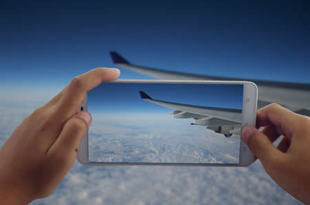 photography aircraft wing flying by phoneの写真素材