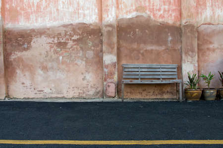 old vintage wooden chair and old colorful wallの写真素材