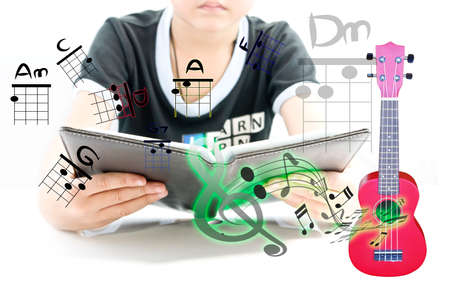 Boy learning for new experience with ukulele for begin playの写真素材