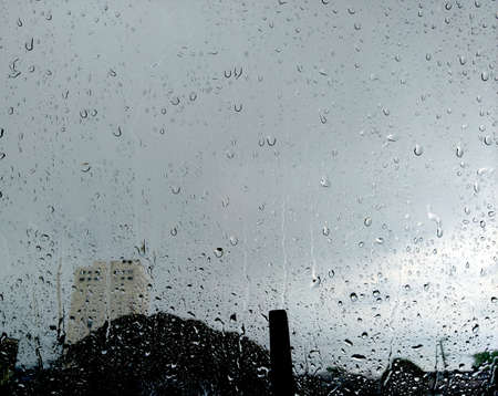 rain, drops on the glass that forms an abstract backgroundの写真素材