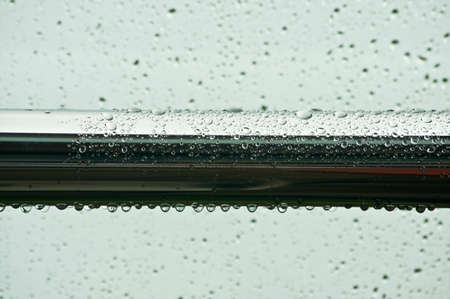 rain, drops on the glass that forms an abstract backgroundの写真素材