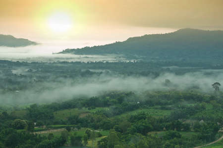 Misty mountains in the distance and sunsetの写真素材