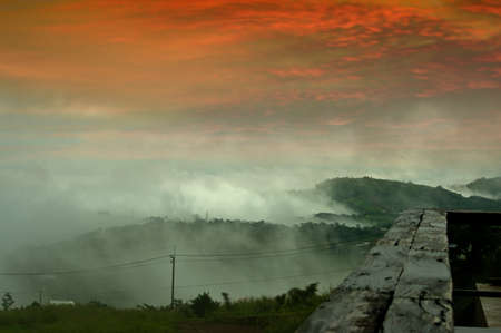 Misty mountains in the distance and sunsetの写真素材