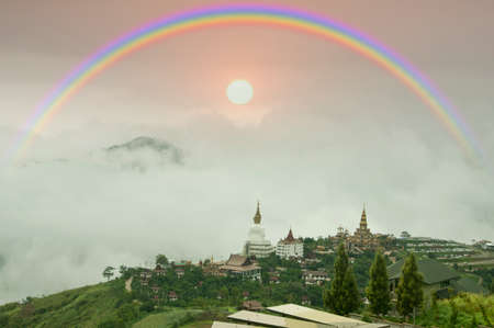 Sky rainbow and misty mountain in the distance and sunsetの写真素材