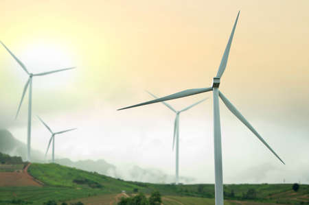 Wind turbine power generators and sunset. Alternative renewable energy production