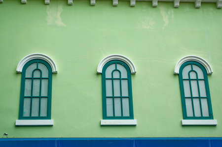 Classic window on green wallの写真素材