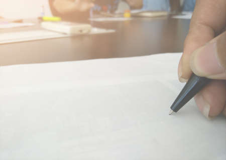 Business meeting, Closeup of hand and note book kept on table in conference roomの写真素材