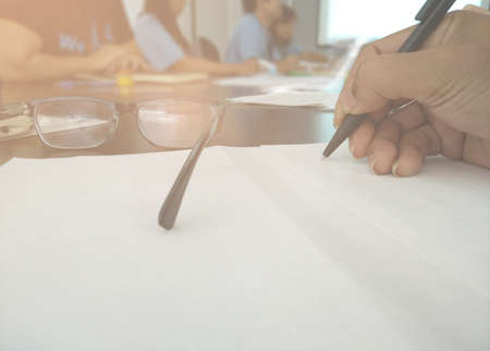 Business meeting, Closeup of hand and note book kept on table in conference roomの写真素材