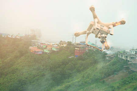 drone quadcopter with high resolution digital camera flying in the sky over the mountain