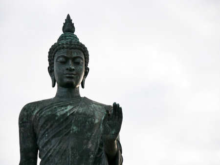 Phra Sri Sakyamasamuthi is a big buddha statue in Phutthamonthon Nakhon Pathom Thailand on sunset with cloudsの写真素材