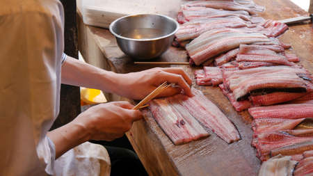Slice eel while they still alive at the old grill eel bowl restaurant in walking way to Narita-san temple in Narita, Japanの写真素材