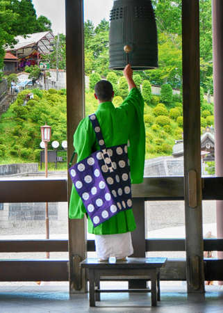 Narita Japan June 14, 2016 : Priest hitting big bell in a Buddhism ceremony in Narita templeのeditorial素材