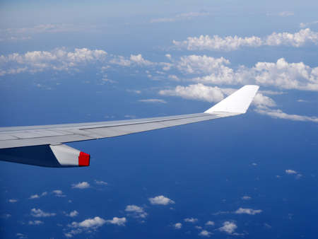 Wing of the airplane on blue sky backgroundの写真素材