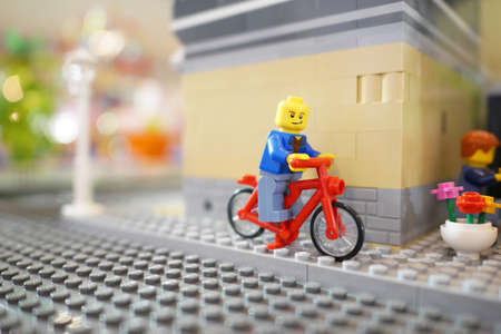 BANGKOK, THAILAND - APR 13, 2015:  Lego toy man sitting in a bicycle in soft focusのeditorial素材
