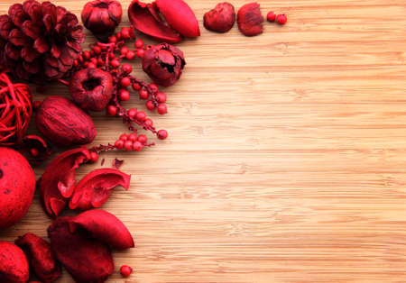 A red berry and fruit potpourri composition against a wooden background with copyspace  Suitable for cards, invitations, advertising の写真素材