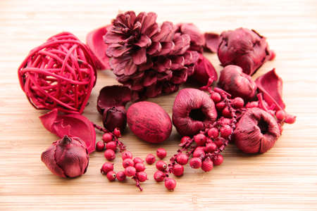 Red scented potpourri for home decoration  nuts, berries, petals and a pine coneの写真素材