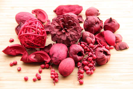 Red scented potpourri for home decoration  nuts, berries, petals and a pine coneの写真素材