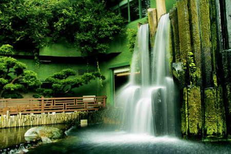 Beautiful waterfall in Chinese Classical Garden called Nan Lian in Hong Kong situated on the Kowloon Island  Blurred motion の写真素材