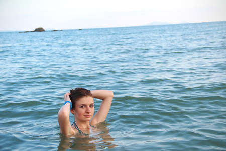 Close up shot of a young female floating in waterの写真素材