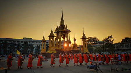 Uthaithani, Muang /Thailand - December 6th 2018 : Hundreds of monks in a row receiving food from...