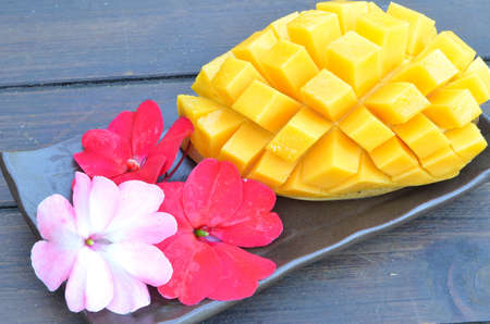 Ripe mango on a ceramic plateの写真素材