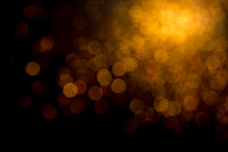 Golden lights bokeh defocus abstract background. Gold Festive Christmas. Glitter twinkled bright background.の写真素材