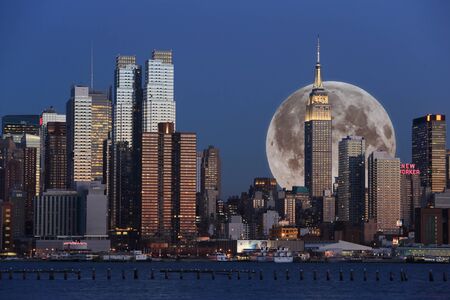 Manhattan Skyline with composed Moon at dusk viewed from NJのeditorial素材