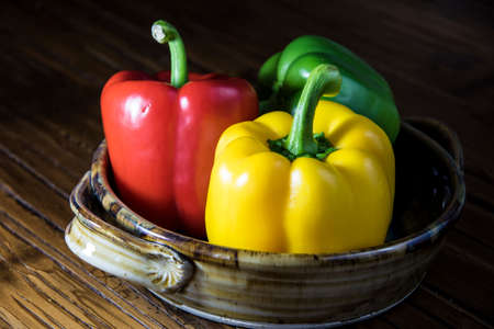 Three bell peppers in a dishの写真素材