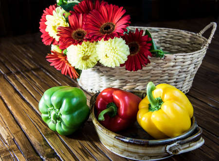 Bell Peppers and flowers in a basketの写真素材