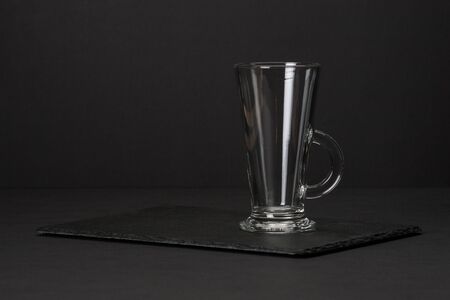 Empty Glass on Slate Stone Mat.の写真素材