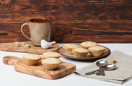 Mince Pies. Traditional Christmas Food. Olive Tree Board. Silver Spoons. Decorations. Wooden Table.の写真素材