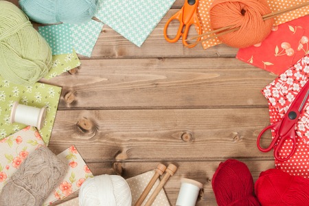Sewing And Knitting Accessories. Fabric, Yarn Balls On Wooden Table. Copy Spaceの写真素材